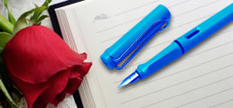 Writing notebook with rose and pen